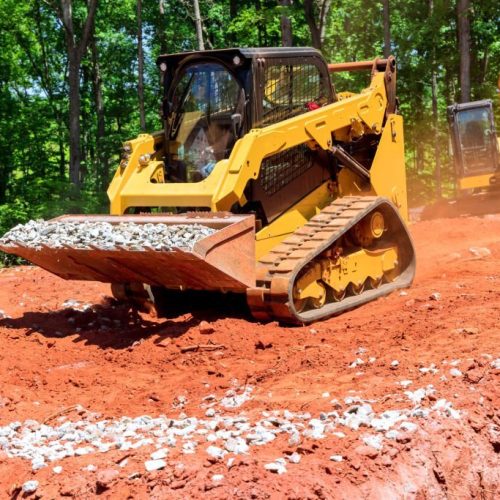 Excavation at a construction site, mini loader bobcat transports crushed stone to different construction places